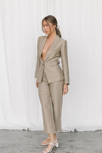 Thumbnail for Model posing in a taupe coloured suit in a studio